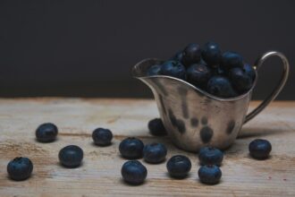 bowl of blackberries on brown wooden surface